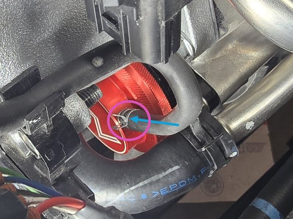 Using a set of pliers, slide up spring clamp to secure the line as shown