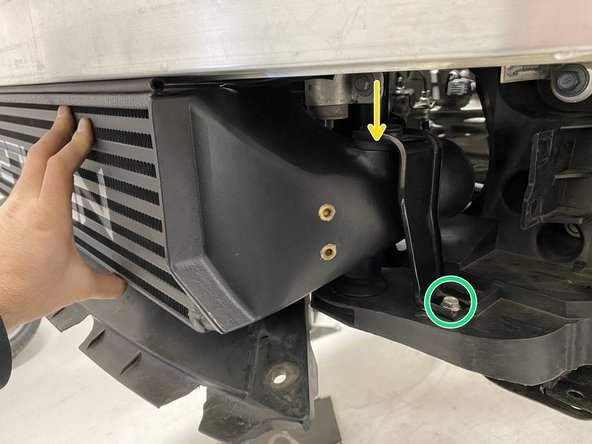 Holding the intercooler at an angle as shown, place the rubber mounts into the pockets