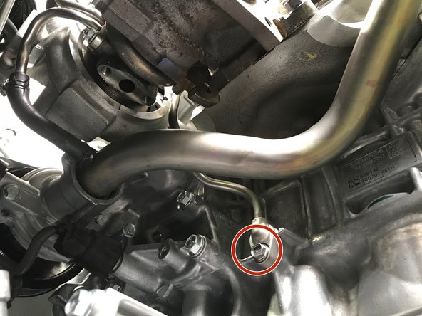 Use a 10mm socket &amp; ratchet to remove the one (1) 10mm bolt holding the lower portion of the oil feed tube