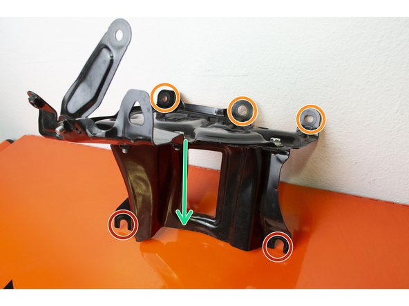 Set the bracket into the engine bay and make sure the lower part is resting on the two lower bolts