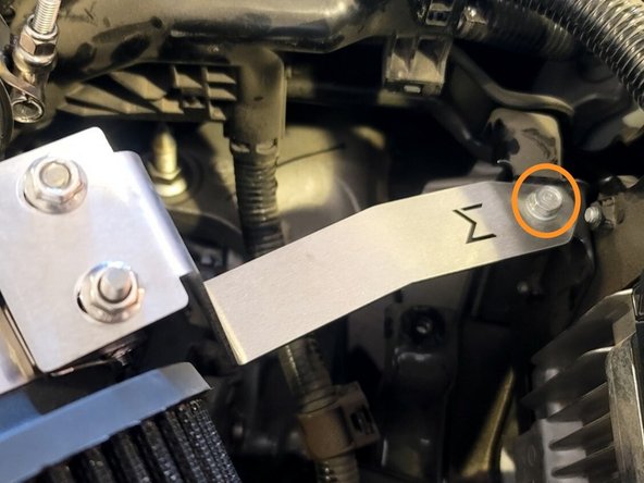 Pull the SRI bracket on top of ECU bracket and finger tighten bolt as shown