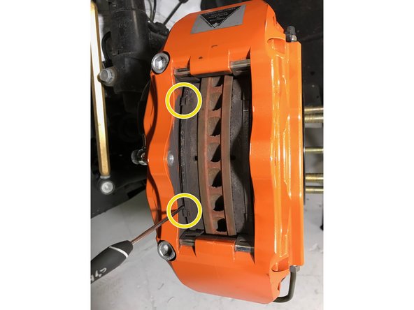 Pull the top and bottom of the brake pad in even increments until the pad can be fully removed