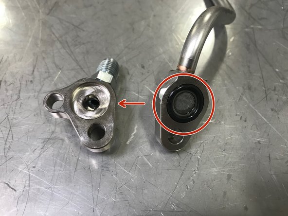 Locate the OE oil feed tube.  Use a small flat head screwdriver to remove the O-ring/screen from the OE oil feed tube