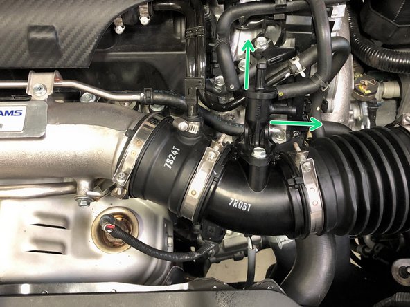 Use needle nose pliers to loosen the OEM spring clamps and slide them up the hoses of the EVAP solenoid