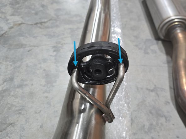 Use tongue &amp; groove pliers to press the rod out of the rubber hanger, remove the rubber support off the OE exhaust hangers as shown