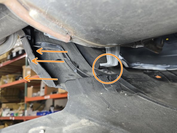 On the topside of the diffuser where the 10mm shoulder bolts mounted, there are brackets that hook into the diffuser. Push the diffuser towards the rear of the car to release it from these mounting tabs