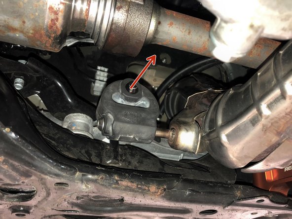 Pull the rubber hanger on the OE front-pipe free from the hanger rod on the chassis in the direction shown