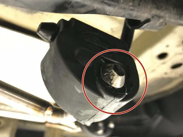 Verify that the bead of the hanger rod is through both forward rubber hangers as shown