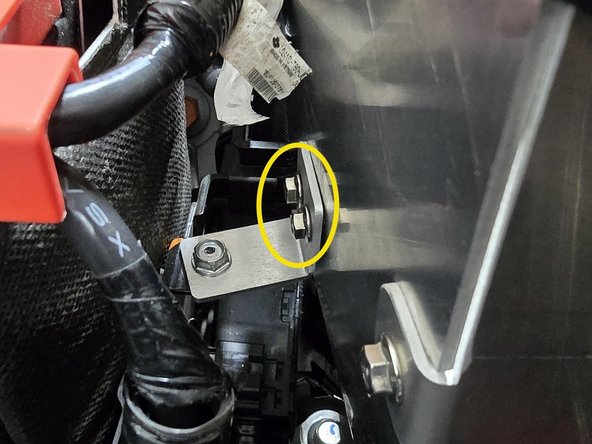 Hand thread the two provided M5 flange nuts onto the bolts as shown