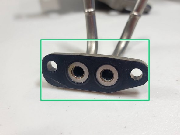 Remove both nuts from OE coolant hardline with 10mm socket and ratchet