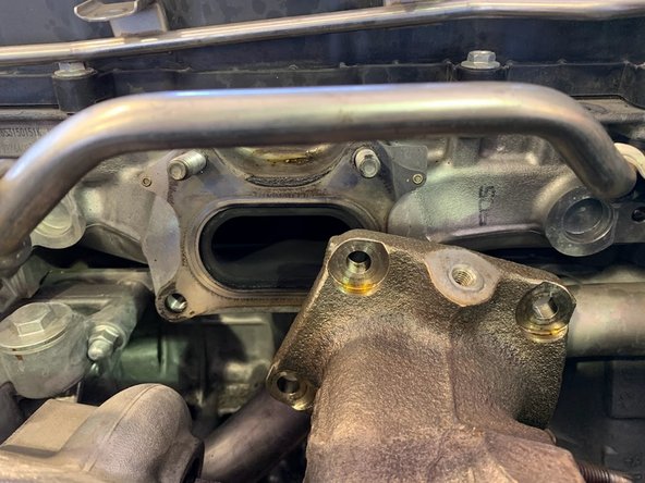 Undo the (2) 14mm bolts on the turbo housing