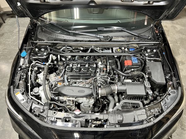 Open the hood to access both the driver and passenger side fender shroud areas