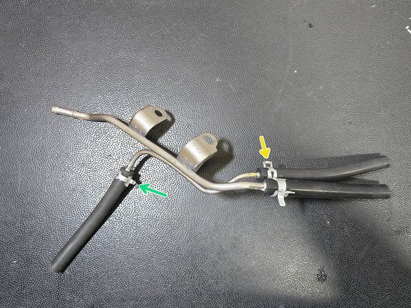 Remove clamp as shown and replace hose with cut piece of silicone hose