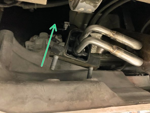 Free the hanger from its mounting location as shown