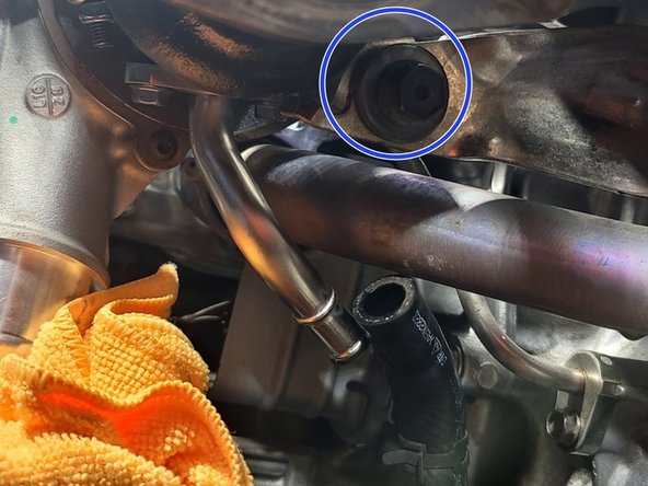 Using the 3/8&quot; drive 14mm socket and ratchet, along with the aid of a breaker bar if necessary, remove the following from the turbine housing of the turbocharger: