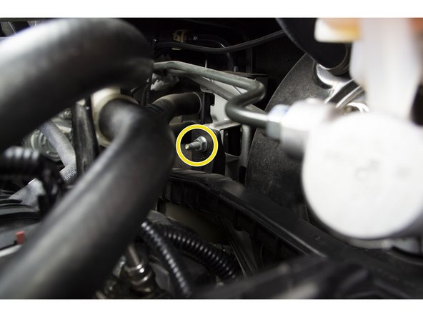 With needle nose pliers pinch the clip and push it out of the bracket