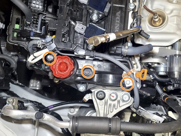 Use a 10mm socket and ratchet to resecure wiring loom and vacuum bracket from step 13