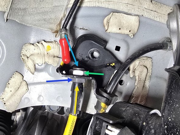 Route the brake line through the chassis mounting bracket in the direction indicated by yellow arrow