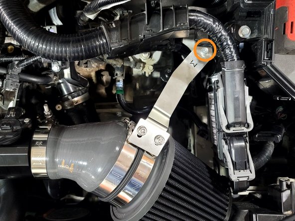 Use a 3/8&quot; drive ratchet and a 10mm socket to remove the bolt securing the SRI bracket to the chassis