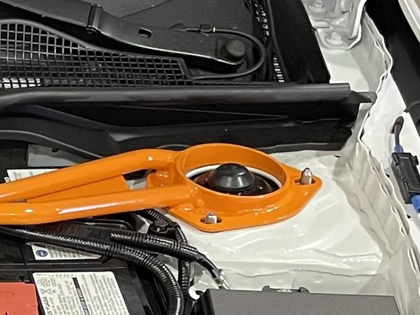 Place each end of the strut bar down on the strut tops over the studs