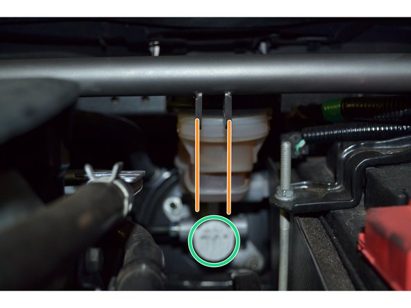 The orange lines show that the mounting tabs will be in line with the master brake cylinder