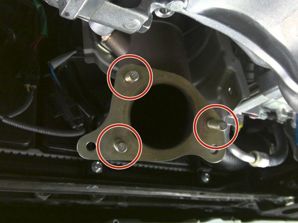 Apply anti-seize to the supplied studs