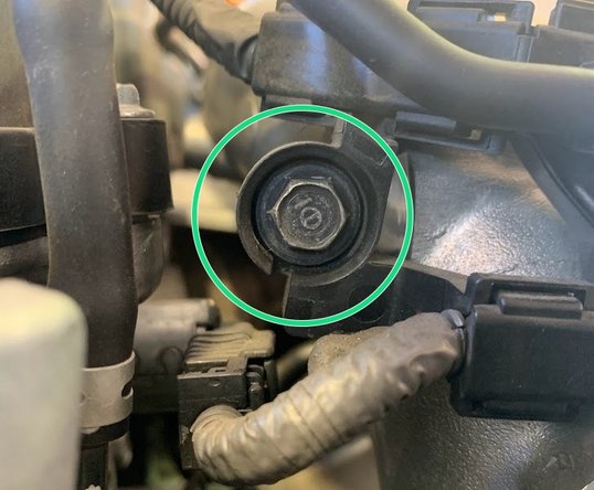 Using  the OE 10mm bolt reinstall the upper part of the vacuum line bracket as shown