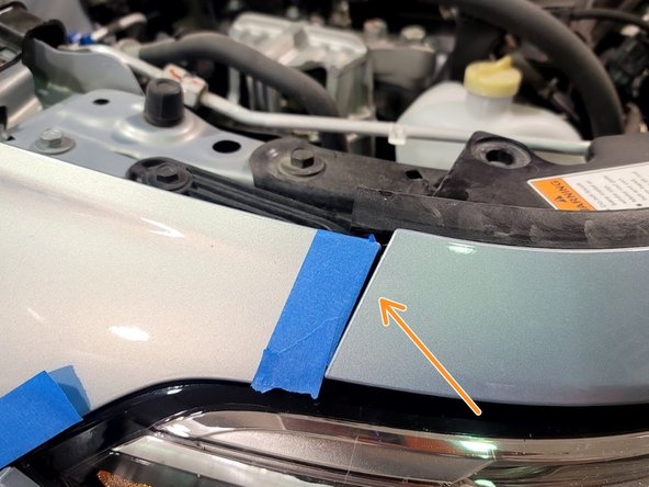 Gently pop off bumper above headlight from it's clip by pulling up and out