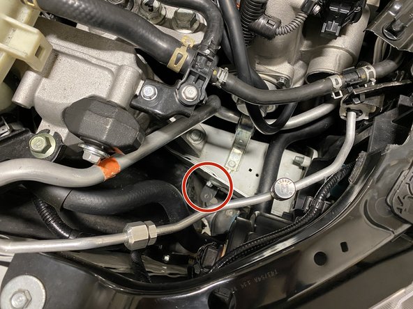 Remove the black metal bracket that supports the OEM hot pipe. Use a 10mm wrench