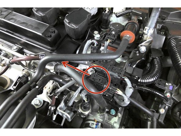 Undo the clip for the secondary O2 sensor plug, and remove the plug