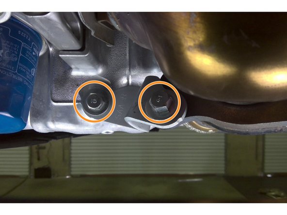 Reinstall the four (4) 14mm bolts securing the two lower downpipe support brackets as shown Torque bolts to 33 ft-lbs