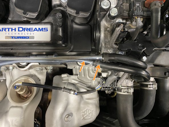 Once you have verified the lower metal pipe has been bent down far enough then by hand bend the metal pipe towards the back of the car slightly - it will end up under the upper metal pipe as shown