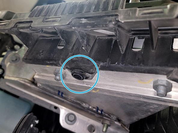 Remove two (2) plastic clips securing underside of plastic cover to the aluminum bumper