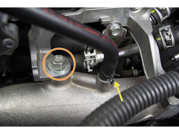 Pinch the hose clamp with needle nose pliers and remove the hose from the charge pipe