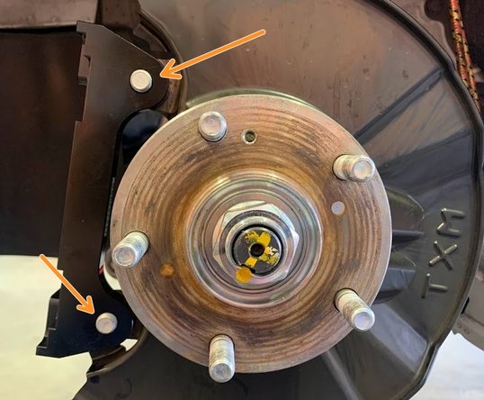 Install provided caliper bracket as shown