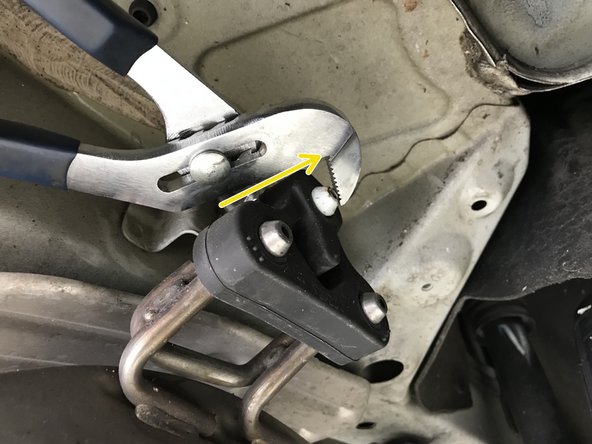 Pull the rubber hanger off the chassis hanger rod as shown