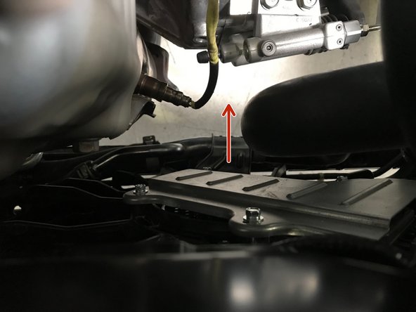 Move the radiator hose back into the correct position so the bolt holes and bracket holes align