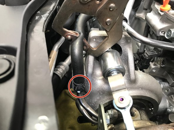 Use pliers to loosen the spring clamp.  Slide the spring clamp up the rubber hose