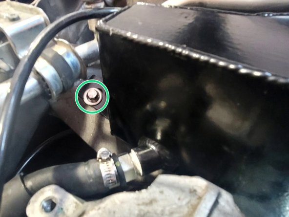 Using a provided M6 washer and a 12mm long M6 flanged bolt, torque to snug down the upper mount bolt for the coolant tank