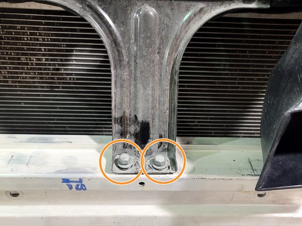 Remove two (2) bolts as shown using 12mm socket and ratchet