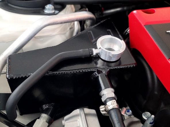 With the cap off the tank start up the car and bleed the system by allowing the car to get to an operating temperature of 170 degF before putting the cap back on