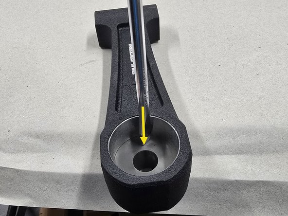 With a flat head screwdriver, press the other piece of poly out