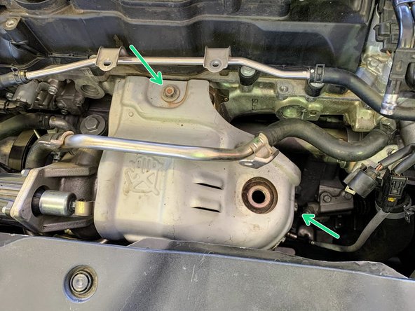 Install the (2) 12mm bolts from the upper part of the heat shield