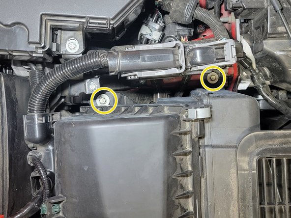 Use a 3/8&quot; drive ratchet, a long extension, and a 10mm socket to remove two (2) bolts that hold the intake in place