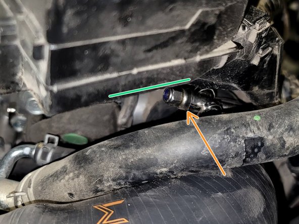 Slide 70-78mm hose clamp over silicone elbow and place elbow on throttle body as shown. Do not secure it yet