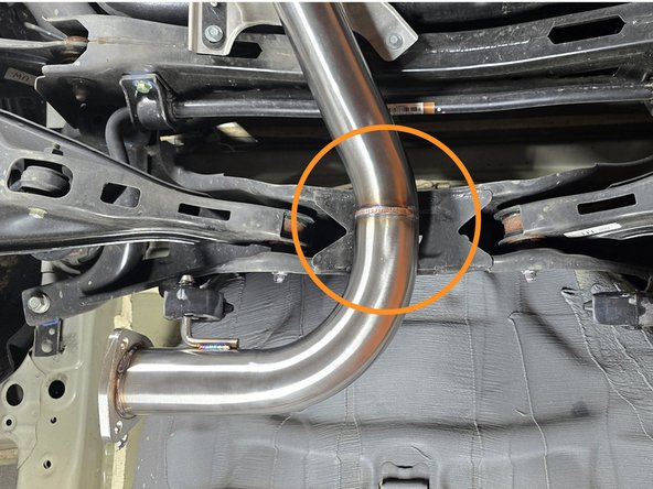 Place forward mid-pipe on front pipe studs as shown. Support the front section with a bungee cord in case it slips off