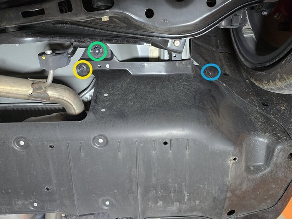 Use a flathead screwdriver or a prying tool to remove the nine (9) plastic push-clips circled in orange