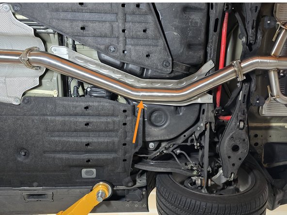 Using provided 35mm hardware install the rearward midpipe in the orientation shown