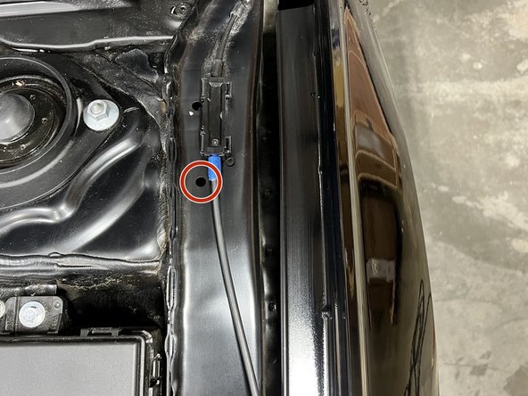 Locate existing small hole on driver-side fender as shown with red circle. Place supplied Riv Nut in hole with red circle