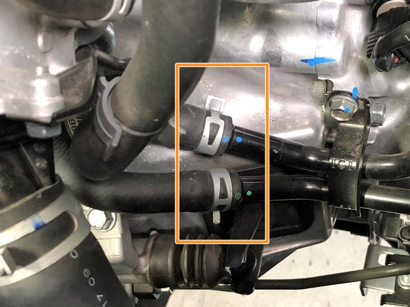 Use needle nose pliers to rotate the upper clamp towards the rear of the car, and the lower clamp towards the front of the car